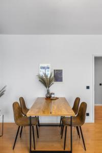einem Esstisch mit Stühlen und einer Pflanze darauf in der Unterkunft Levax Living - 61 qm - Cozy - close to the city in Leipzig