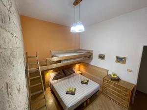 a bedroom with a bunk bed and a ladder at Casa Mia in Donnalucata