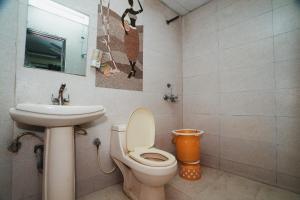a bathroom with a toilet and a sink at Hotel A V International in New Delhi