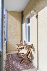 eine Terrasse mit einem Tisch und einem Stuhl auf dem Balkon in der Unterkunft Levax Living - 61 qm - Cozy - close to the city in Leipzig