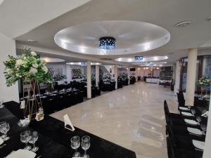 a banquet hall with a long table with wine glasses at Caprice Deluxe Accomodation in Drobeta-Turnu Severin
