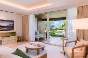 a living room with a view of the ocean at COMO Uma Canggu in Canggu