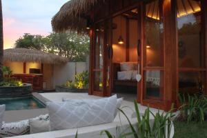 a resort with a bed and a swimming pool at The Cove Gili Air in Gili Air