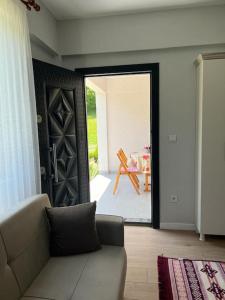 a living room with a couch in front of a door at Machka Resort in Trabzon