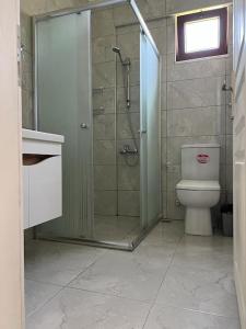 a bathroom with a shower and a toilet at Machka Resort in Trabzon