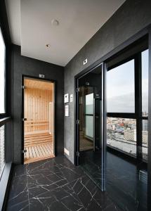 a hallway with black walls and a wooden door at Condo Edge Central in Pattaya
