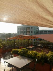 a patio with tables and umbrellas on a building at Hotel Nuvò in Naples