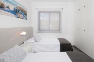 A bed or beds in a room at Meloneras Bay Suites