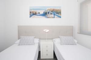 A bed or beds in a room at Meloneras Bay Suites