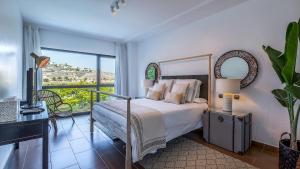 a bedroom with a bed and a large window at Salobre Golf Villas Premium in Salobre +50 photos