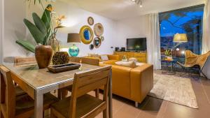 a living room with a couch and a table at Salobre Golf Villas Premium in Salobre