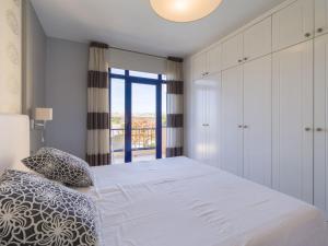 A bed or beds in a room at Meloneras Bay Suites