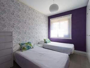 A bed or beds in a room at Meloneras Bay Suites