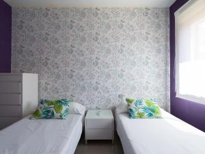 A bed or beds in a room at Meloneras Bay Suites