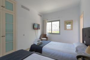 Ein Bett oder Betten in einem Zimmer der Unterkunft Tauro Villas Deluxe