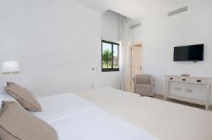 Ein Bett oder Betten in einem Zimmer der Unterkunft Tauro Villas Deluxe