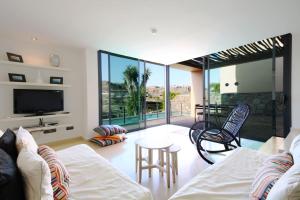 a living room with a couch and a tv at Salobre Villas Deluxe in Salobre