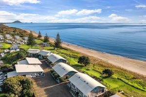 an aerial view of a beach with a group of rvs at Tasman Holiday Parks - Papamoa Beach in Papamoa
