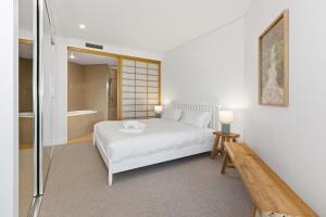 a bedroom with a bed and a walk in shower at Cotton Beach 53 by Kingscliff Accommodation in Casuarina