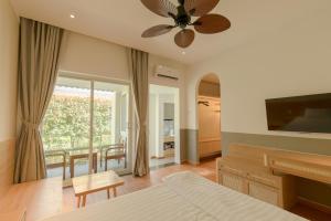 a bedroom with a bed and a ceiling fan at Tây Tiến Bungalow in Phú Quốc