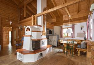 a living room with a stove and a dining room at Brabander Hütte in Gaschurn
