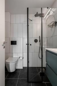 a bathroom with a shower and a toilet and a sink at Mate GEORGE - By HOMY in Tel Aviv