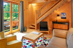 a living room with a couch and a table at Hotel du Golf in Corrençon-en-Vercors