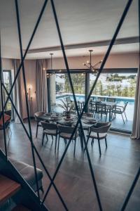 a dining room with tables and chairs and a large window at Villa IVaLA in Pula