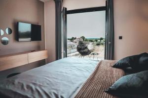 a bedroom with a bed and a window with a view at Villa IVaLA in Pula