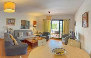 a living room with a table and chairs and a living room at Zahara almadraba playa Atlanterra in Zahara de los Atunes