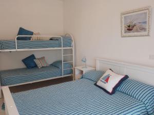 a room with two bunk beds and a bed at Borgonovo casa relax in Pizzo