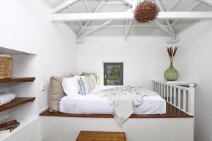 a bedroom with white walls and a bed in a room at Villa John's Skopelos Stafilos in Skopelos Town