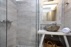 a bathroom with a sink and a mirror at Villa John's Skopelos Stafilos in Skopelos Town +29 photos