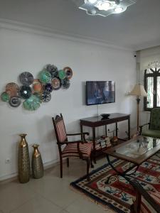 a living room with a table and plates on the wall at Sevo Hotel in Ayvalık