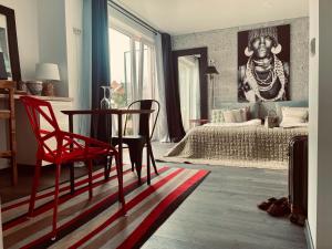a bedroom with a bed and a table and chairs at SURF HOUSE DREAMERS COAST in Klaipėda +49 photos
