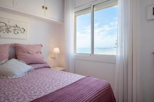 Schlafzimmer mit einem Bett und Meerblick in der Unterkunft AT101 Baix a Mar in Torredembarra