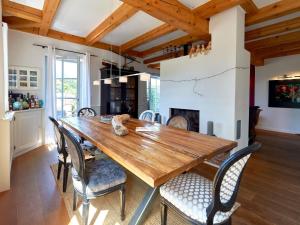 a dining room with a wooden table and chairs at Fachwerkhäuser Seedorf - Villa "Johanna Maria" mit Kamin, Sauna, Terrasse, Wasserblick in Sandort