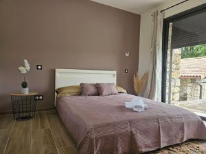 a bedroom with a large bed with a towel on it at Villa & Spa Luxuria in Massels +22 photos