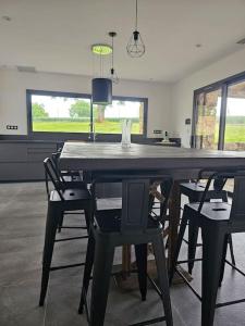 a dining room with a large table and chairs at Villa & Spa Luxuria in Massels