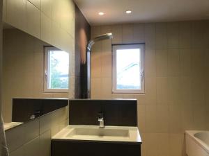 a bathroom with a sink and a window at une maison avec piscine chauffée in Mouguerre +4 photos