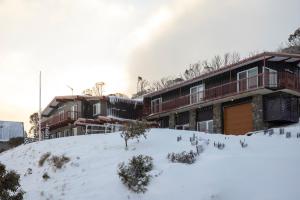 um edifício com neve em frente em Guthega Inn em Perisher Valley