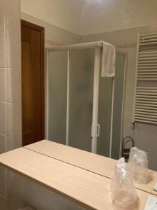 a bathroom counter with a mirror and a shower at Agriturismo Altana Del Motto Rosso in Gattico