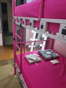 a pink bunk bed with two pillows on it at 2 bedroom, 4 beds, apartment in El sheikh Zayed Cairo Egypt in Sheikh Zayed