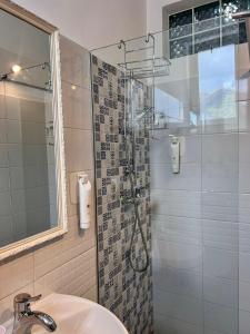 a bathroom with a shower and a sink at Pension Old City in Braşov