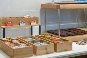 a display of boxes of food on a table at Plaza de la Luz Cádiz in Cádiz