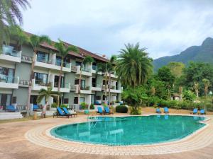 a hotel with a swimming pool in front of a resort at Chang Buri Resort & Spa in Ko Chang