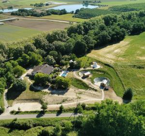an aerial view of a farm with a house and trees at Domaine QUIESCIS in Marcellus