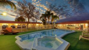 a swimming pool in the yard of a motel at Charles Rasp Motor Inn & Cottages in Broken Hill