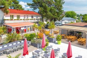 an aerial view of a restaurant with tables and umbrellas at Azureva Pornichet Baie de La Baule in Pornichet +14 photos