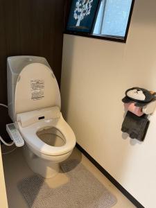 a bathroom with a white toilet in a room at ABC accommodation in Osaka